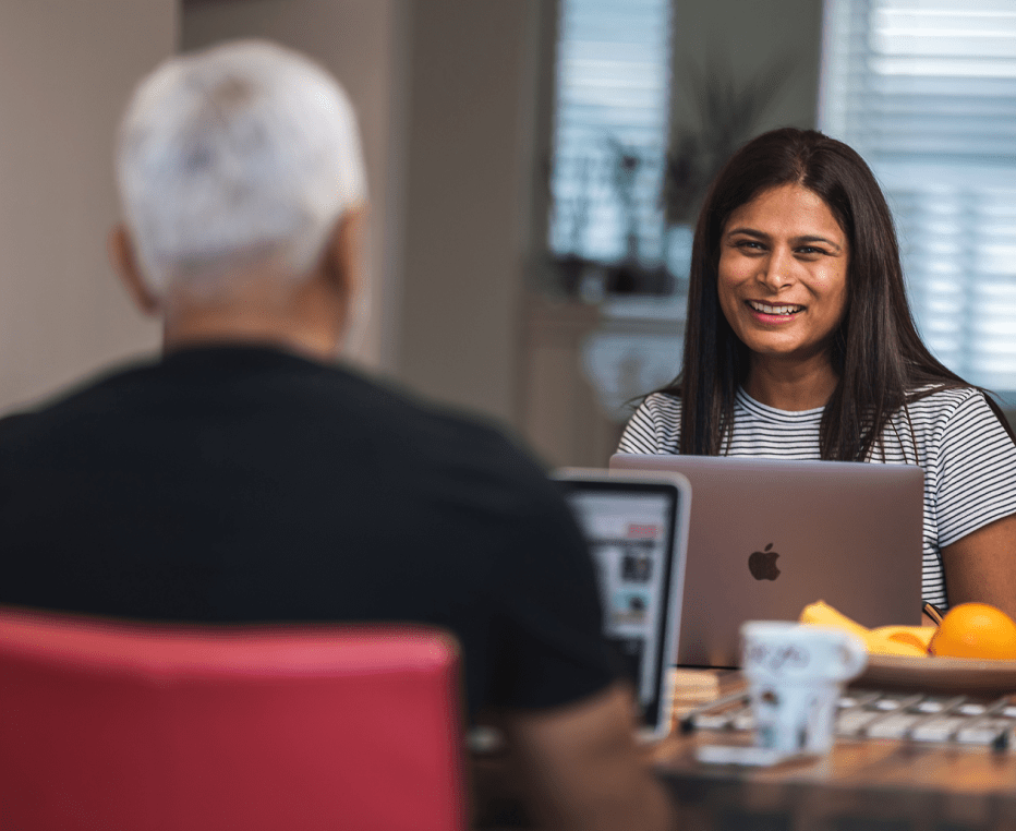 Customer experience expert working from home, interacting with her partner